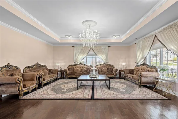 a living room with furniture and a chandelier