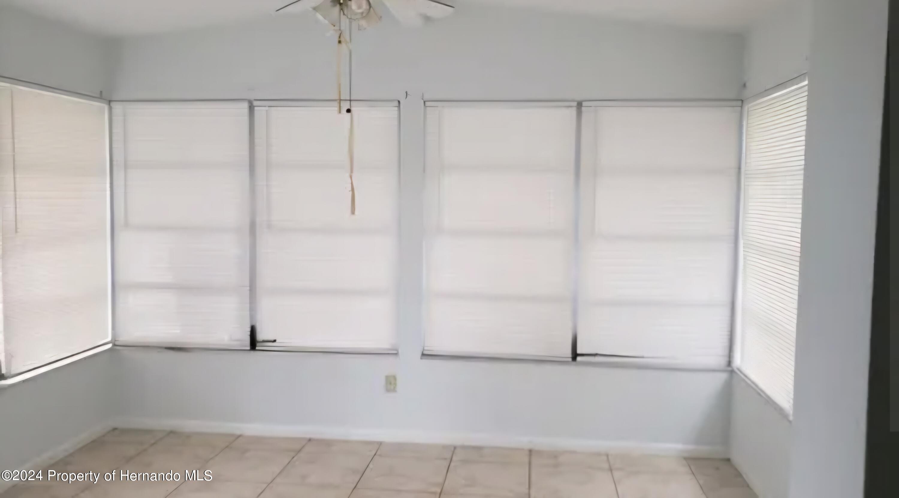 7054 Fireside Street Spring Hill, FL 34606 - Photo 3 of 17 a view of an empty room