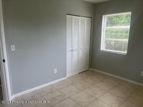 7054 Fireside Street Spring Hill, FL 34606 - Photo 9 of 17 an empty room with windows