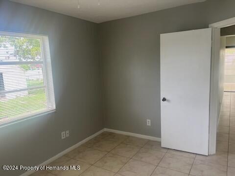 7054 Fireside Street Spring Hill, FL 34606 - Photo 10 of 17 a view of an empty room with a window