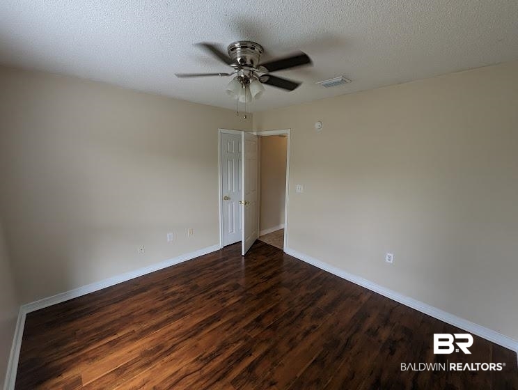12971 Labradors Run Foley, AL 36535 - Photo 10 of 23 Spacious interior room featuring rich wood-finish flooring, neutral wall tones, and white baseboards