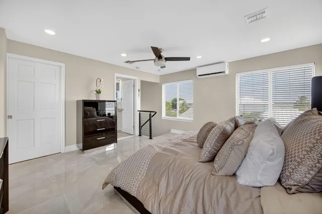 a spacious bathroom with a granite countertop sink mirror and toilet
