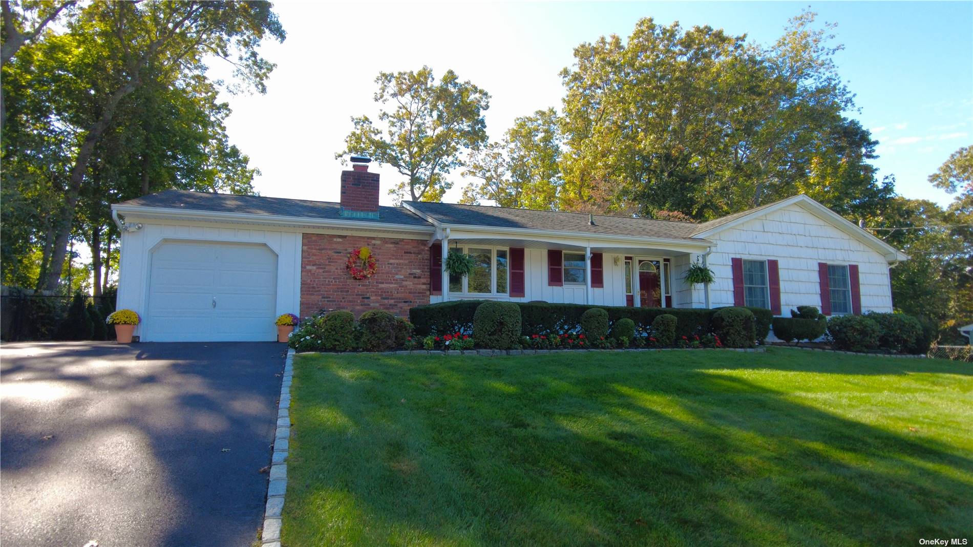 83 Mahogany Road Rocky Point, NY 11778 - Photo 1 of 1 a front view of a house with a garden and yard