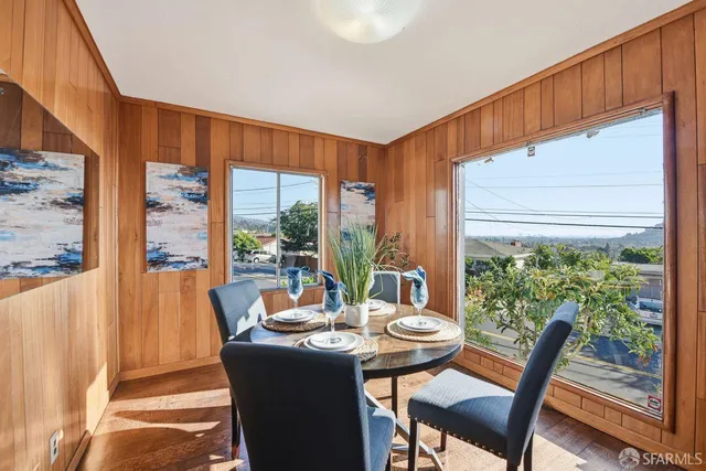 a view of a dining room with furniture window and outside view