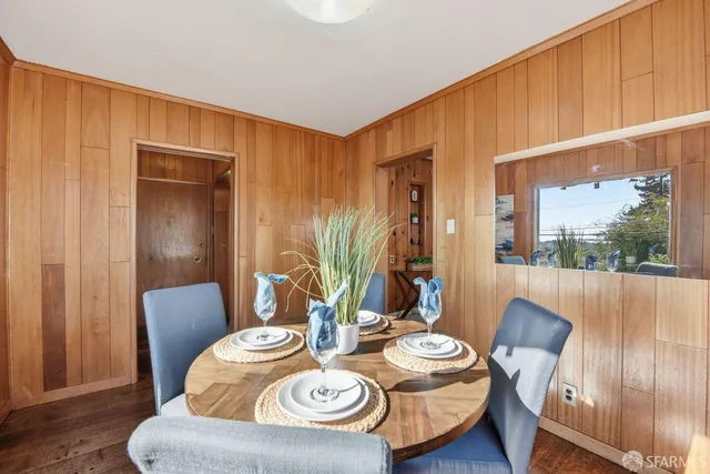 a dining room with furniture and wooden floor