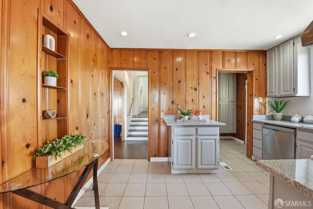 a large kitchen with a refrigerator and table