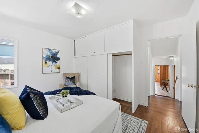 a bedroom with furniture and a wooden floor