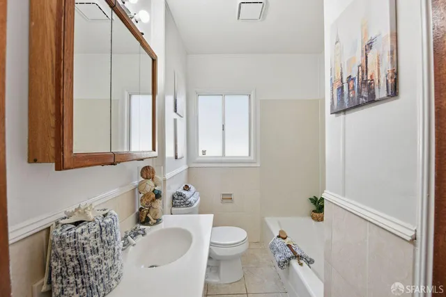 a bathroom with a sink toilet and mirror