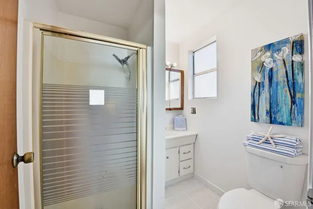 a bathroom with a toilet a sink and shower