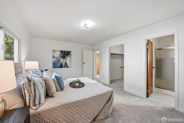 a bedroom with three beds and a table