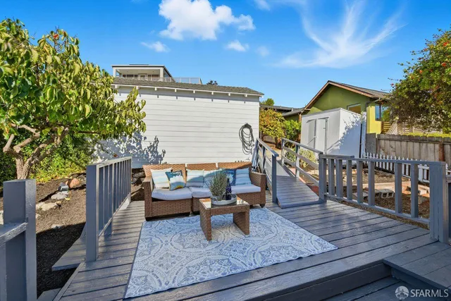 a view of a roof deck with couches and wooden floor