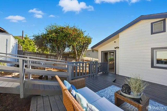 a balcony with wooden floor and furniture