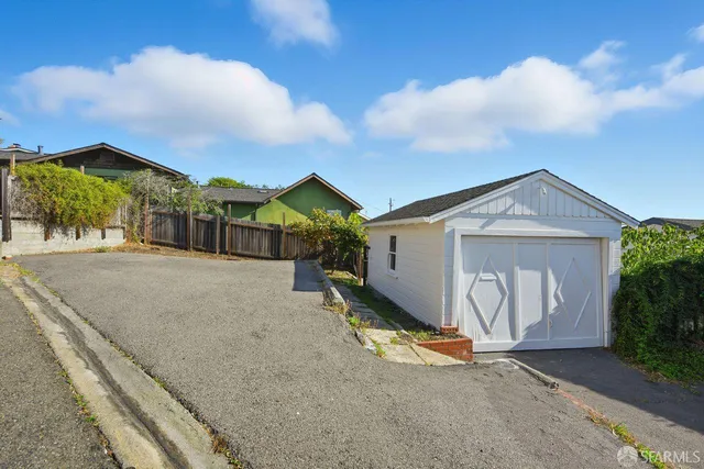 a view of a house with a yard and garage