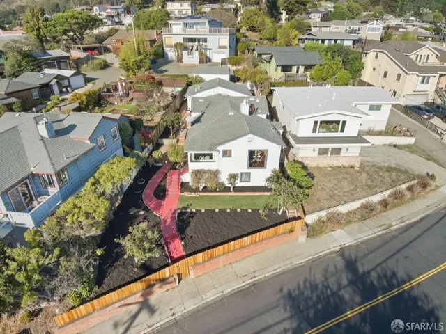 an aerial view of residential houses with outdoor space