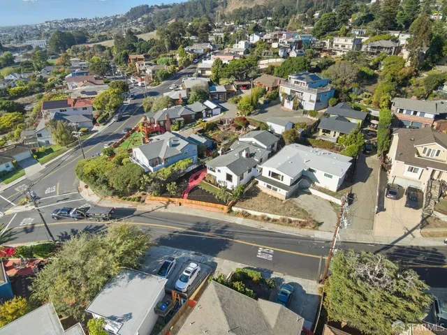 an aerial view of a residential houses with outdoor space