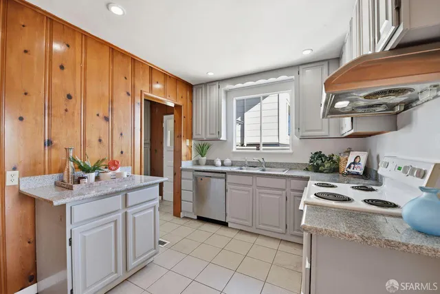 a kitchen with stainless steel appliances a sink stove and cabinets