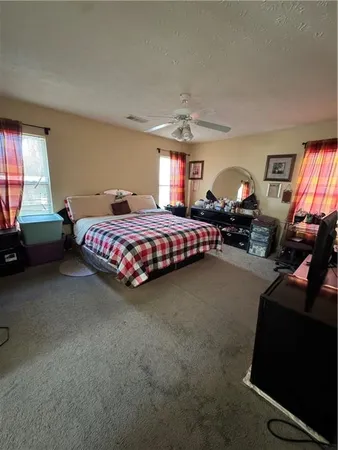 a bedroom with bed and window