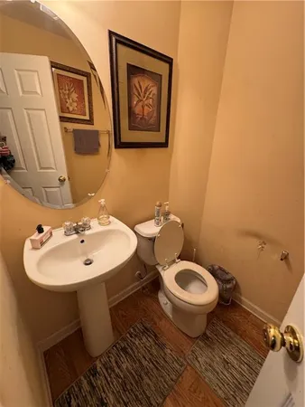 a bathroom with a sink toilet and a mirror