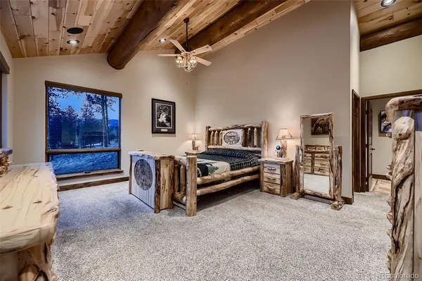 a bathroom with a granite countertop sink a mirror and shower