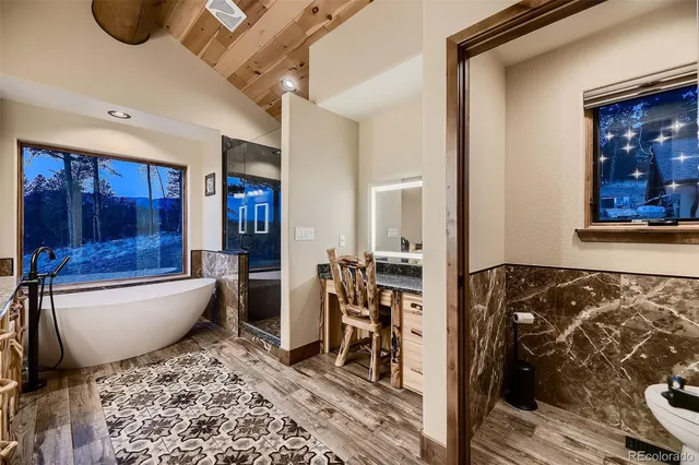 a bathroom with a granite countertop shower a mirror and a sink