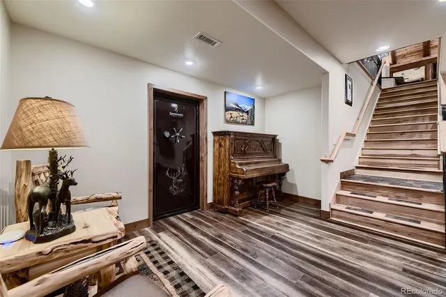a bathroom with a granite countertop sink a mirror and a shower