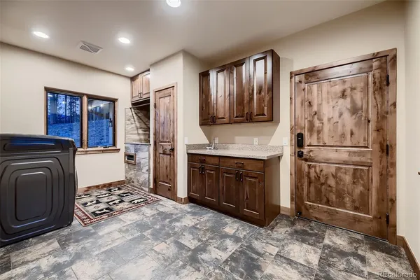 a bathroom with a granite countertop sink a mirror and a shower