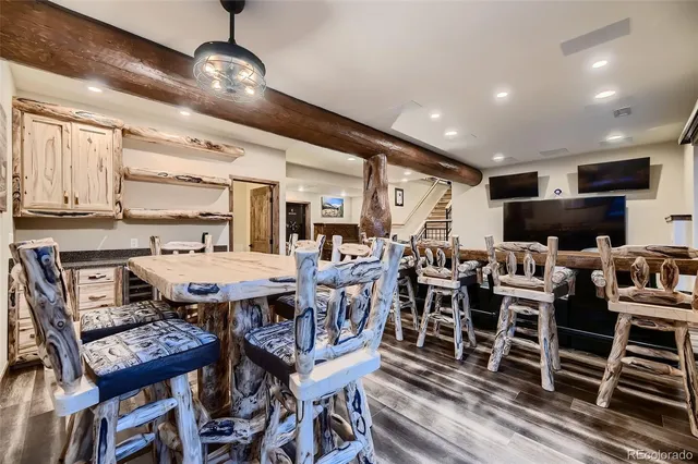 a view of a house with large trees and wooden fence