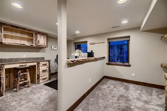a living room with furniture a ceiling fan and a flat screen tv
