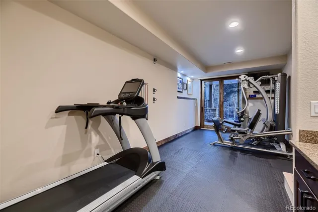 a bathroom with a granite countertop sink a toilet and shower