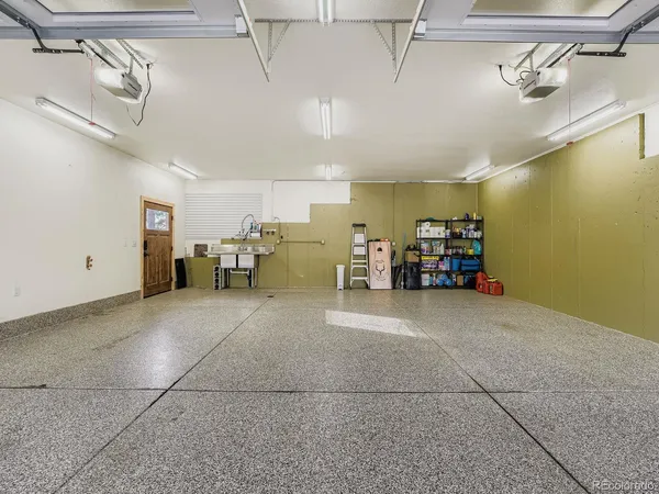 a bathroom with a granite countertop sink a toilet and shower
