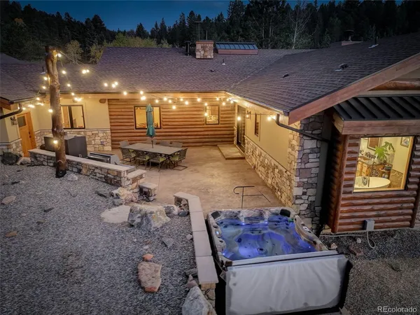 a dining hall with couches a flat tv screen and a dining table with wooden floor