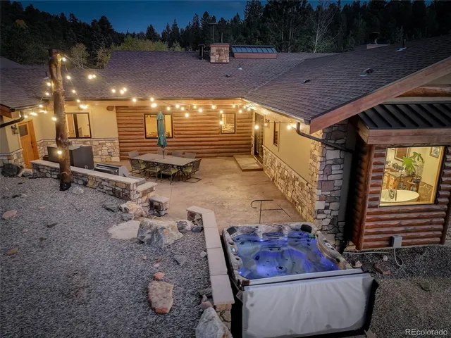 a dining hall with couches a flat tv screen and a dining table with wooden floor