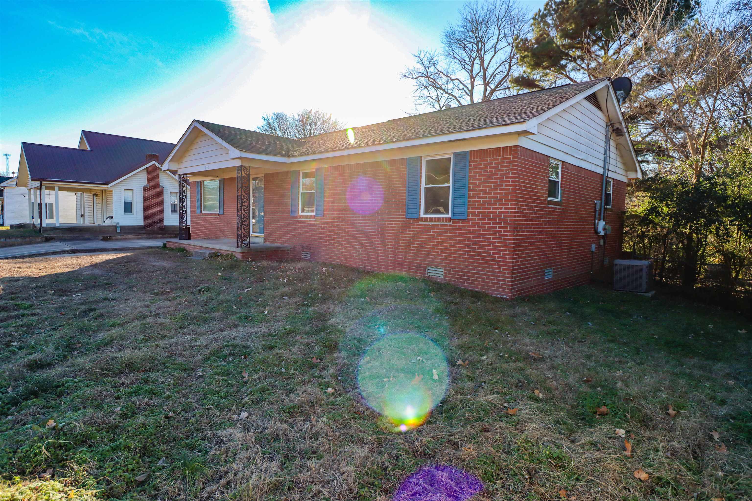 211 Washington Street Newbern, TN 38059 - Photo 14 of 28 a front view of a house with a yard