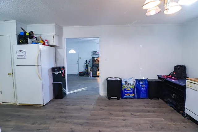 a view of a kitchen with refrigerator and toys
