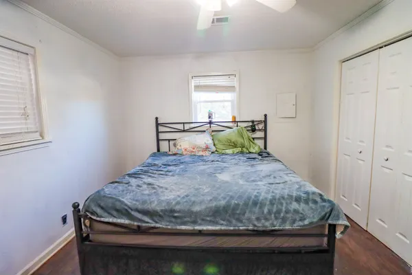 a bedroom with a bed and a chandelier