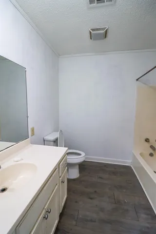 a bathroom with a sink a toilet and vanity