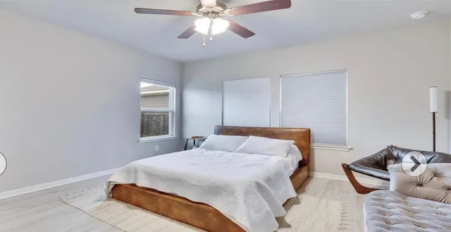 a bedroom with a bed and window