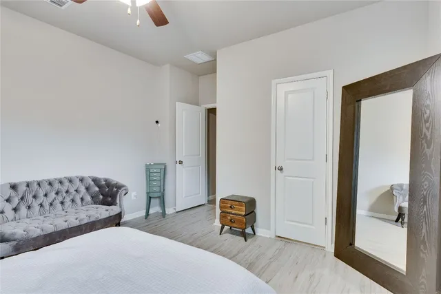 a bedroom with a bed and a couch