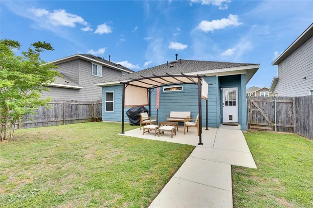 a front view of house with yard and outdoor seating