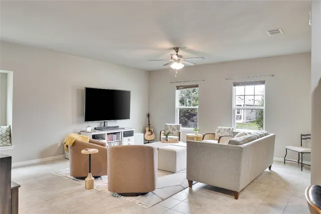 a living room with furniture and flat screen tv