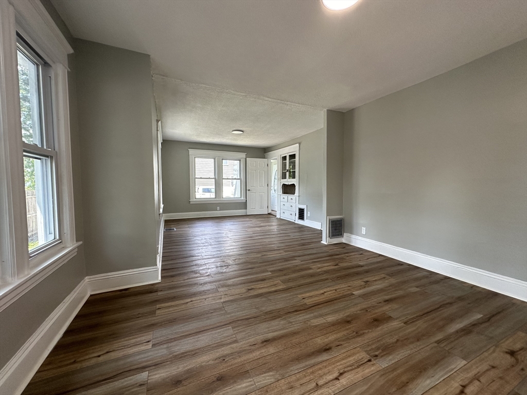 4 Langdon Street Springfield, MA 01104 - Photo 8 of 33 a view of an empty room with wooden floor and a window