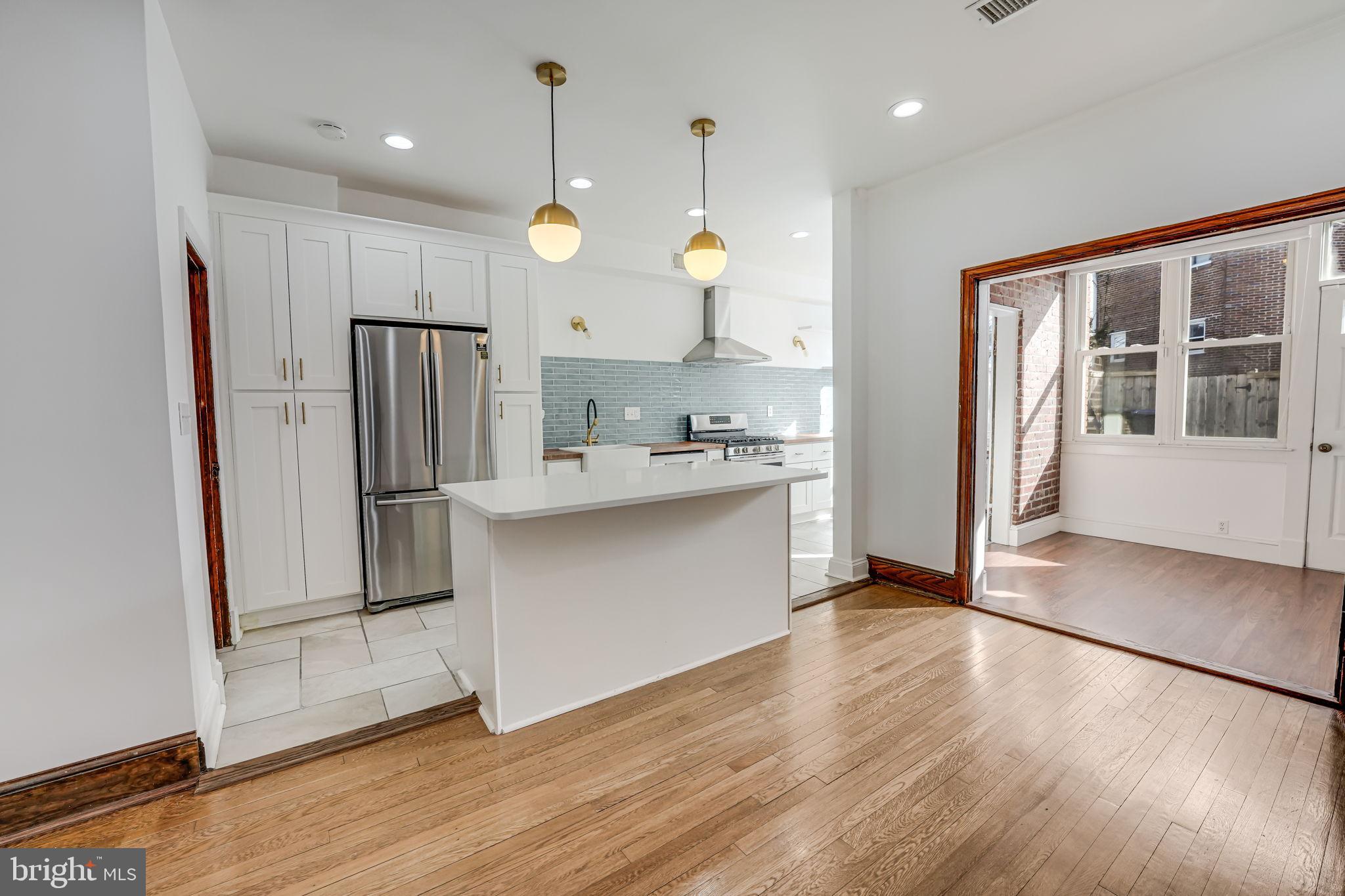 1304 Rittenhouse Street Northwest Washington, DC 20011 - Photo 13 of 50 a large kitchen with a large window and stainless steel appliances