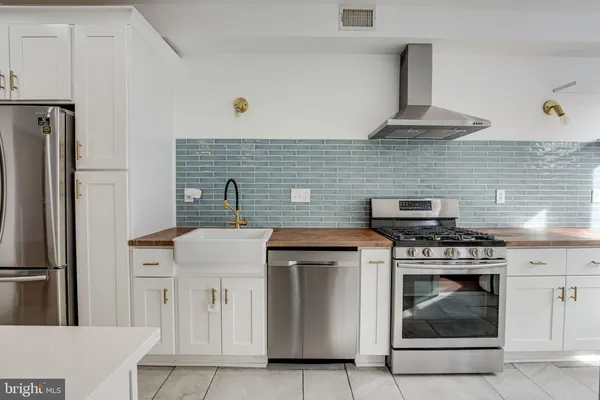 a kitchen with a sink and a stove top oven