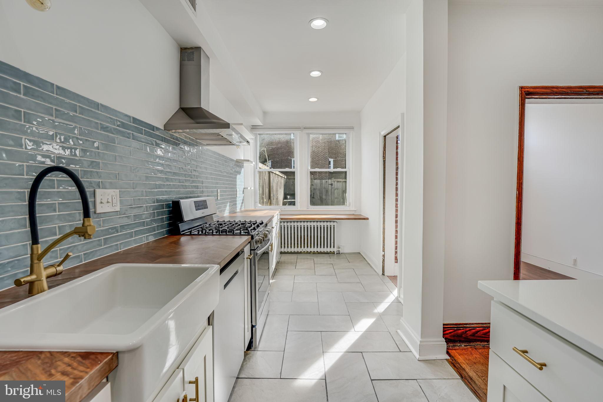 1304 Rittenhouse Street Northwest Washington, DC 20011 - Photo 16 of 50 a kitchen with a sink and a stove top oven