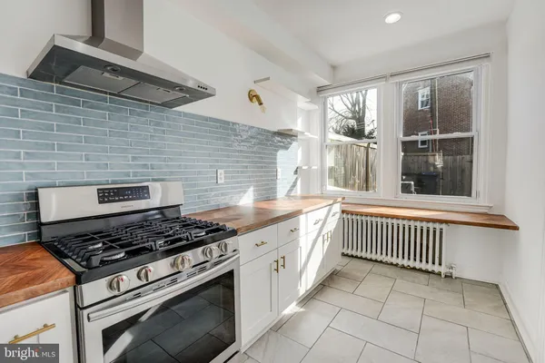 a kitchen with a stove and a sink