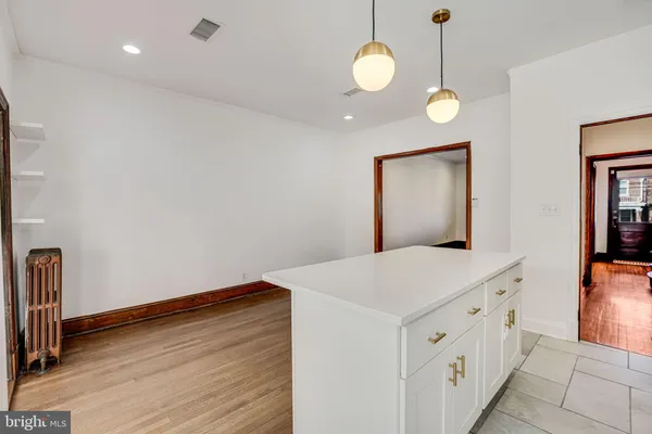 a view of a hallway with wooden floor and entryway