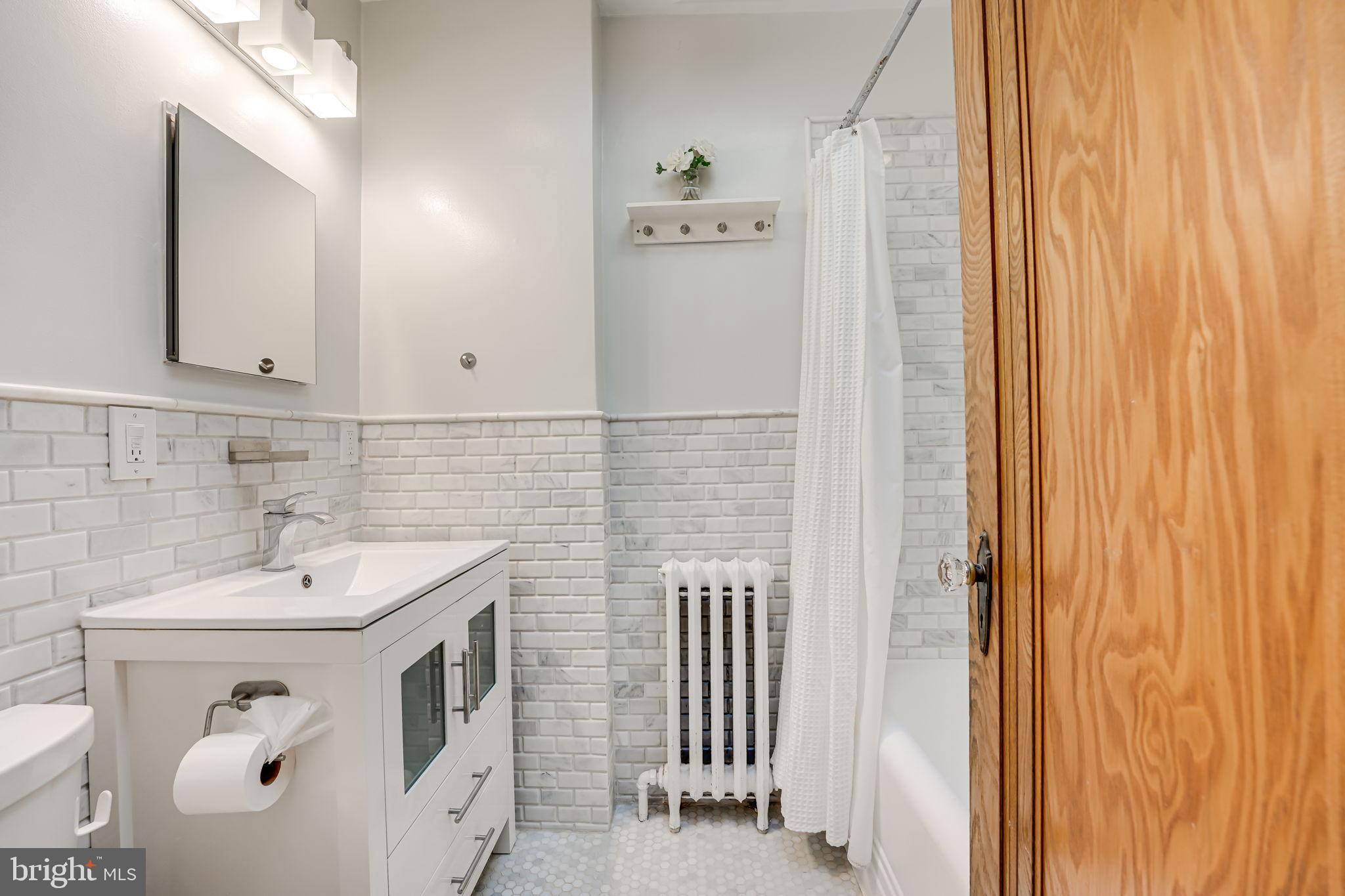 1304 Rittenhouse Street Northwest Washington, DC 20011 - Photo 24 of 50 a bathroom with a sink and a mirror