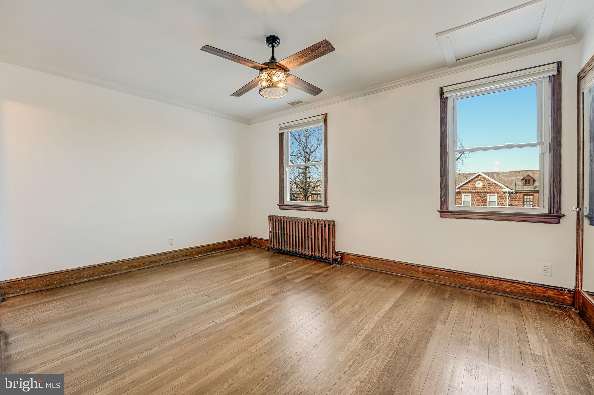 1304 Rittenhouse Street Northwest Washington, DC 20011 - Photo 27 of 50 a view of an empty room with wooden floor and a window