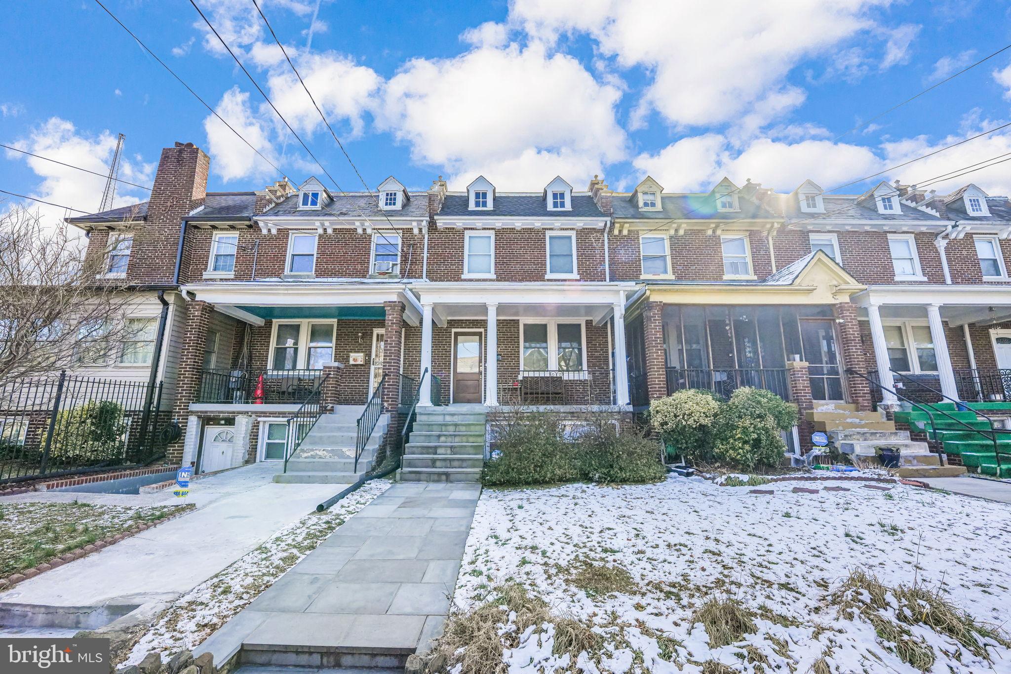 1304 Rittenhouse Street Northwest Washington, DC 20011 - Photo 3 of 50 a front view of a residential apartment building with a yard