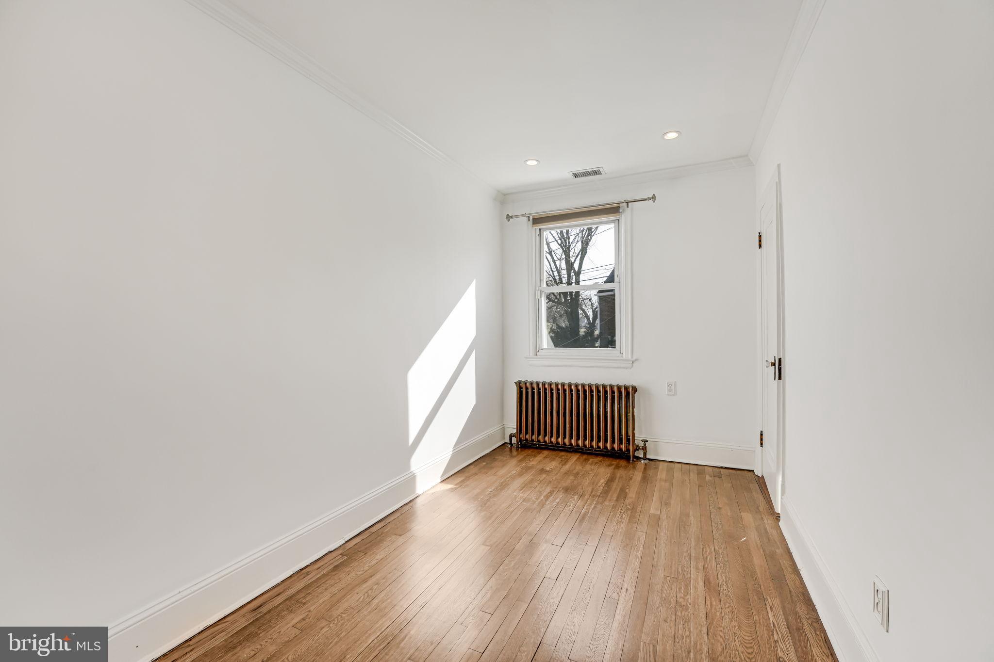 1304 Rittenhouse Street Northwest Washington, DC 20011 - Photo 31 of 50 an empty room with wooden floor and windows